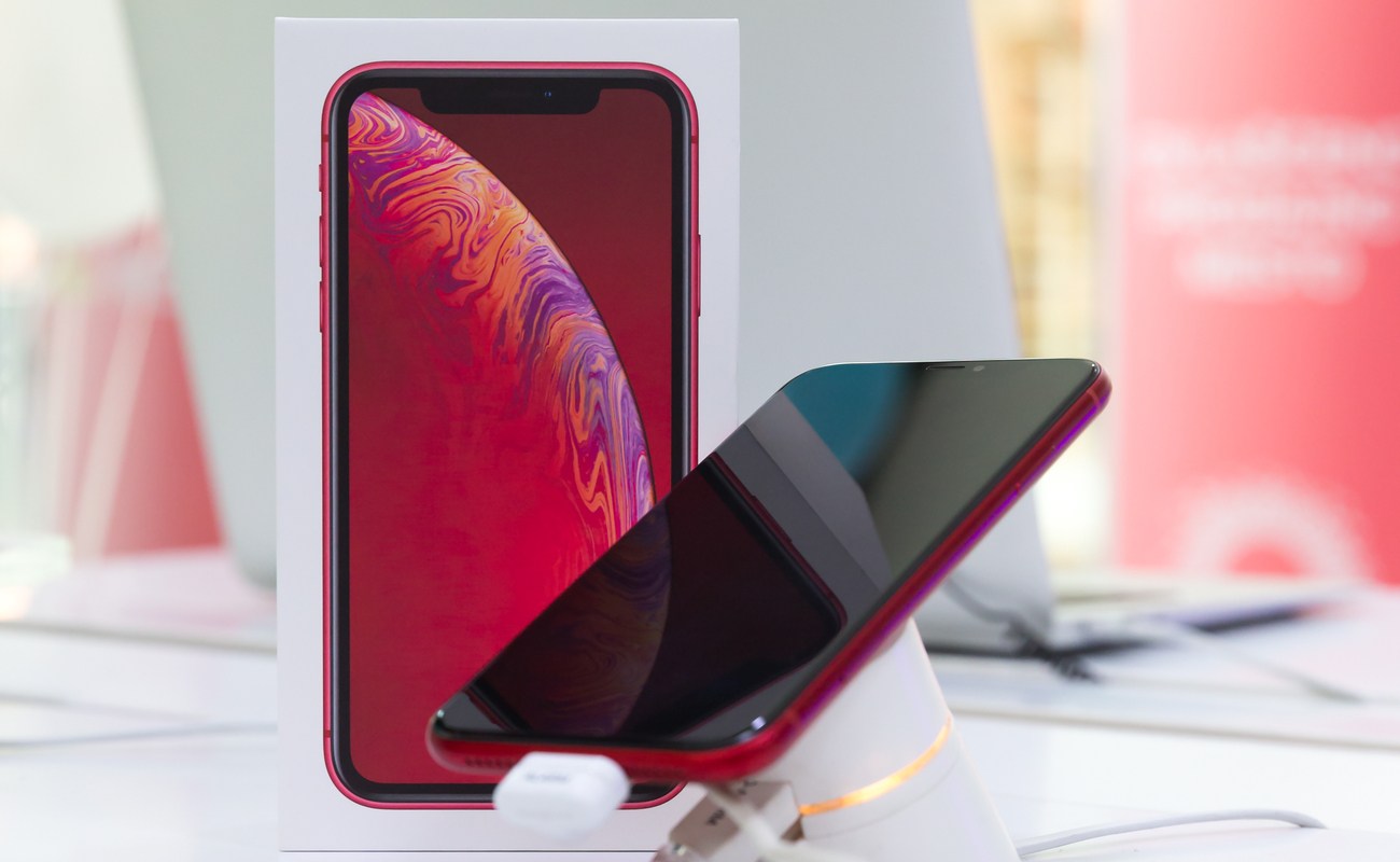 Red iPhone XR on display inside a shop