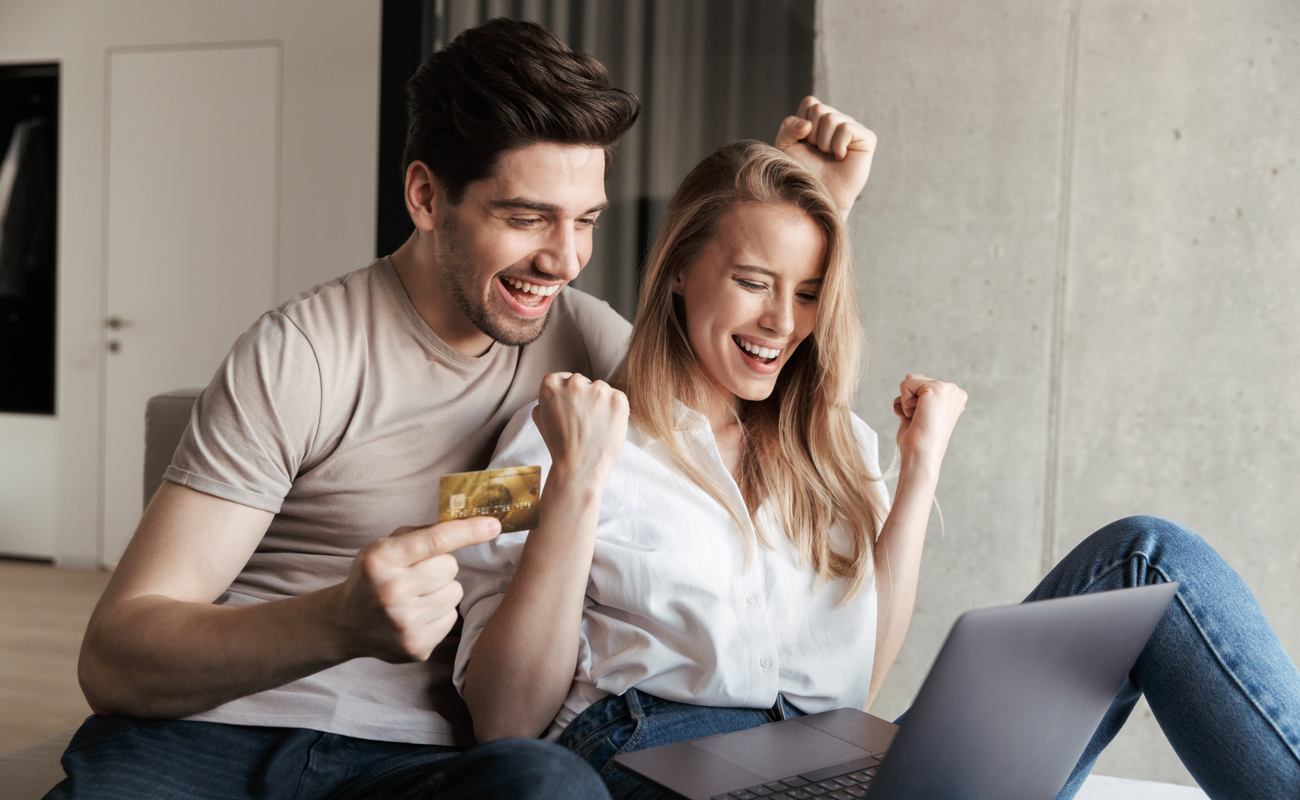 Man and woman celebrating winning on online casino