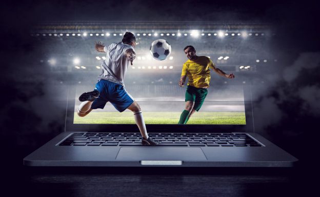 Football players shown through a laptop screen