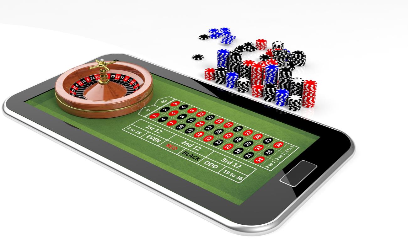 Online casino concept with tablet, roulette and chips isolated