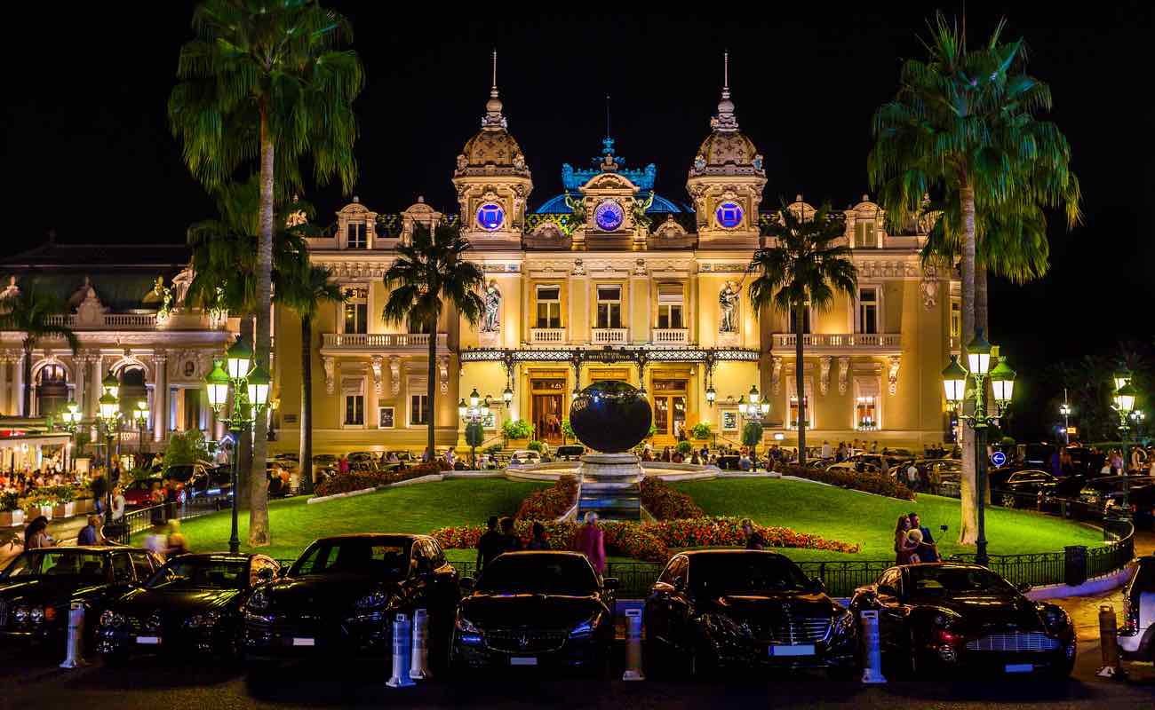 The grand Casino Monte at night with illuminated facade.