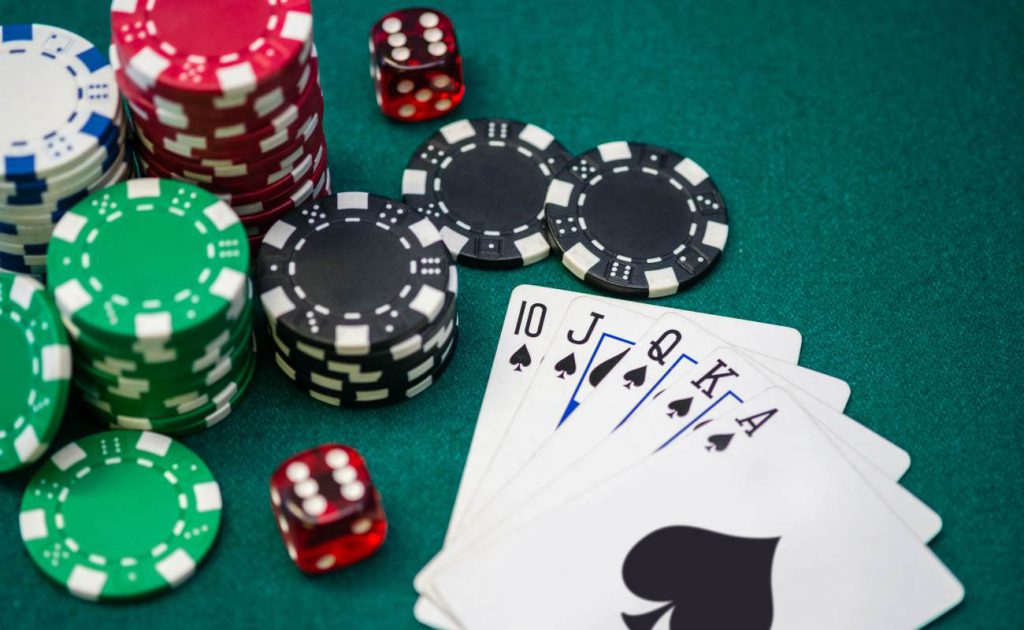 Poker chips, dice and poker cards on gambling table