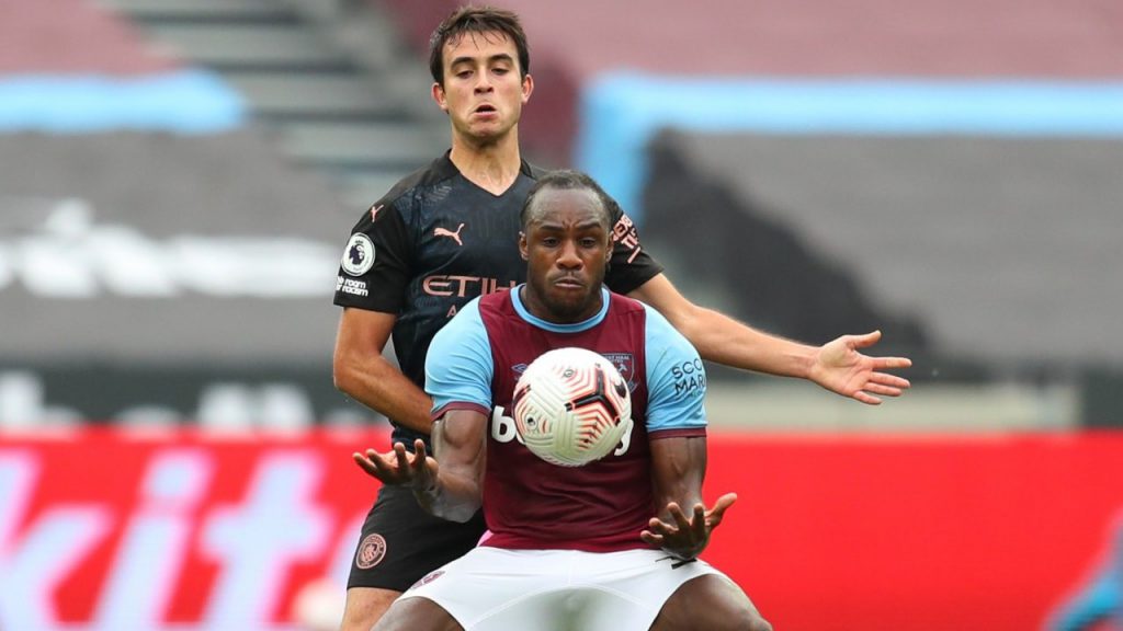 West Ham striker Michail Antonio shields the ball from a Manchester City player in the Premier League