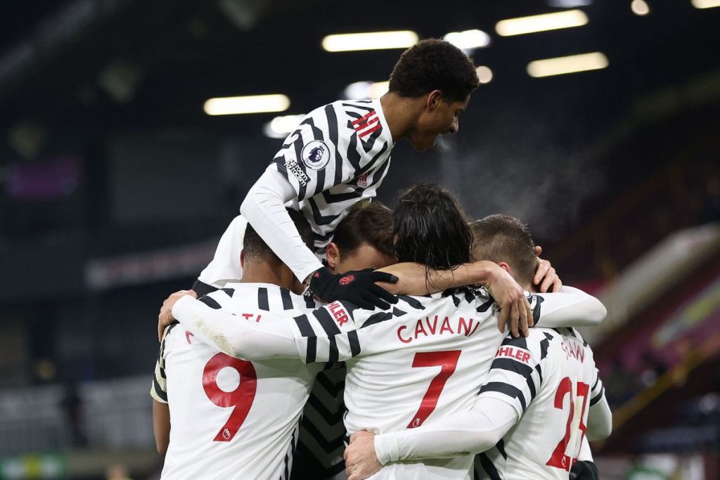 Manchester United players, including Marcus Rashford, celebrate a Premier League goal